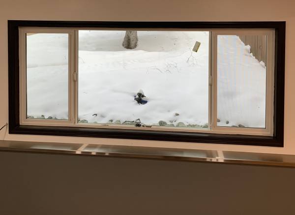 Finished room with a wide replacement window and dark trim